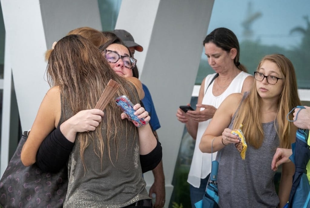 Families and friends of residents brace for bad news. Photo: EPA