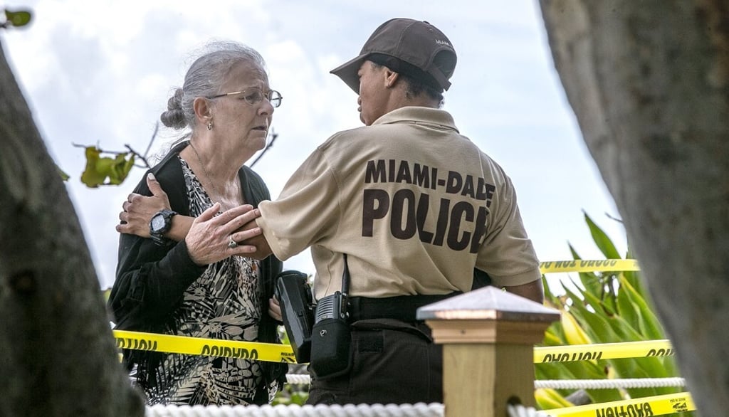 A Miami-Dade police officer comforts a woman at the site of the Champlain Towers South building in Surfside, Florida. Photo: Miami Herald / TNS