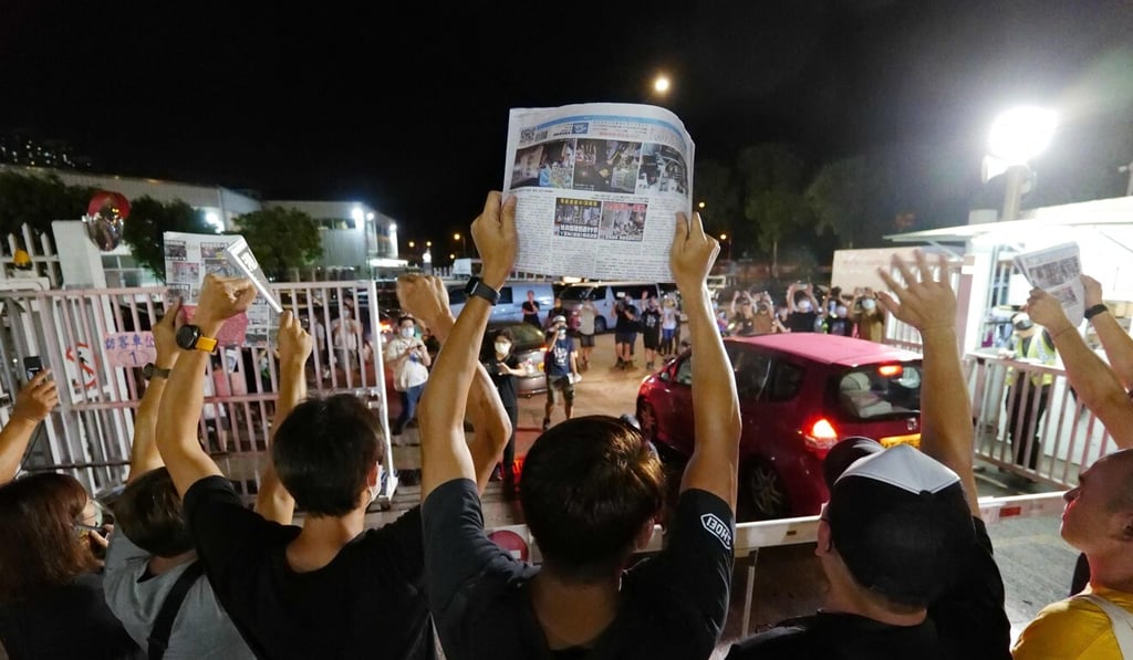 Apple Daily journalists hold freshly-printed copies of the newspaper's last edition while acknowledging supporters gathered outside their office in Hong Kong early last week as the tabloid was forced to close after 26 years under the city’s new national security law. Photo: AFP Apple Daily journalists hold freshly-printed copies of the newspaper's last edition while acknowledging supporters gathered outside their office in Hong Kong early last week as the tabloid was forced to close after 26 years under the city’s new national security law. Photo: AFP