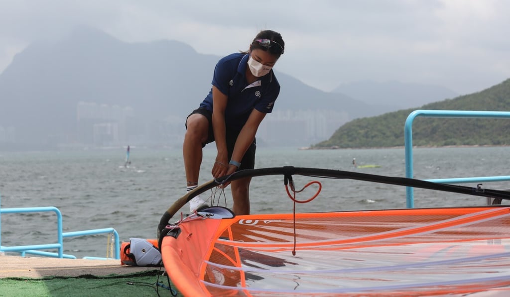 Hong Kong windsurfing athlete Hayley Chan Hei-man prepares her fin at the Hong Kong Federation of Youth Groups in Tai Mei Tuk Water Sports Centre in Tai Po in June.