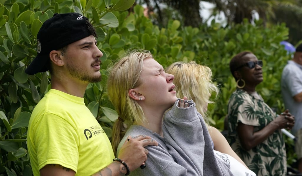 Ariana Hevia, of New Orelans, stands with Sean Wilt, near the partially collapsed building on Friday. Hevia's mother lives in the building. Search and rescue teams continued to work at the site on Monday hoping to detect any sounds coming from survivors. Photo: AP