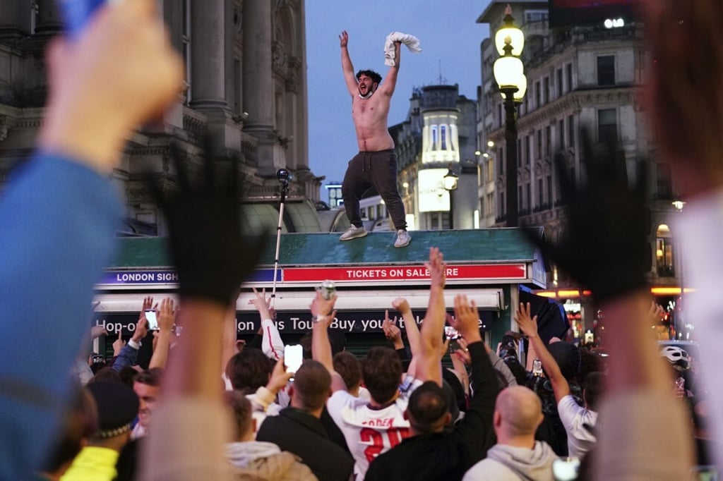 England football fans in Piccadilly Circus, London, celebrate victory in the Euro 2020 match against Germany on Tuesday. Photo: PA via AP
