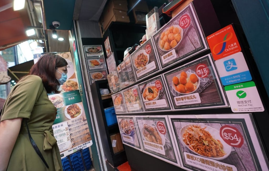 A restaurant in Hong Kong’s Tsim Sha Tsui district displays three cashless payment options – Octopus, Alipay and WeChat Pay – alongside its menu, on June 7, 2021. Photo: Felix Wong.