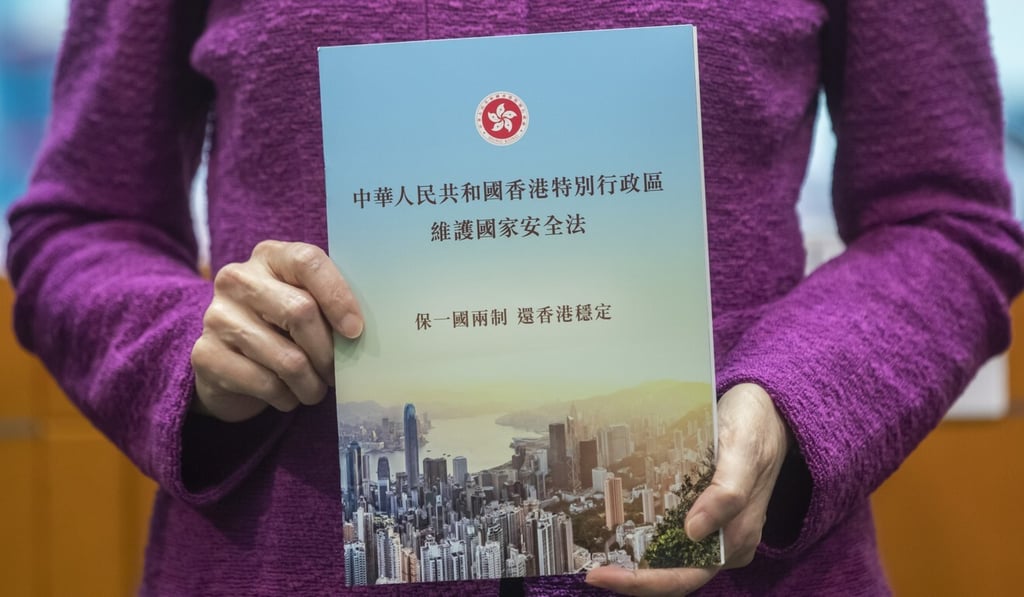 City leader Carrie Lam holds a copy of the new national security law at a press conference on July 1, 2020. Photo: Bloomberg