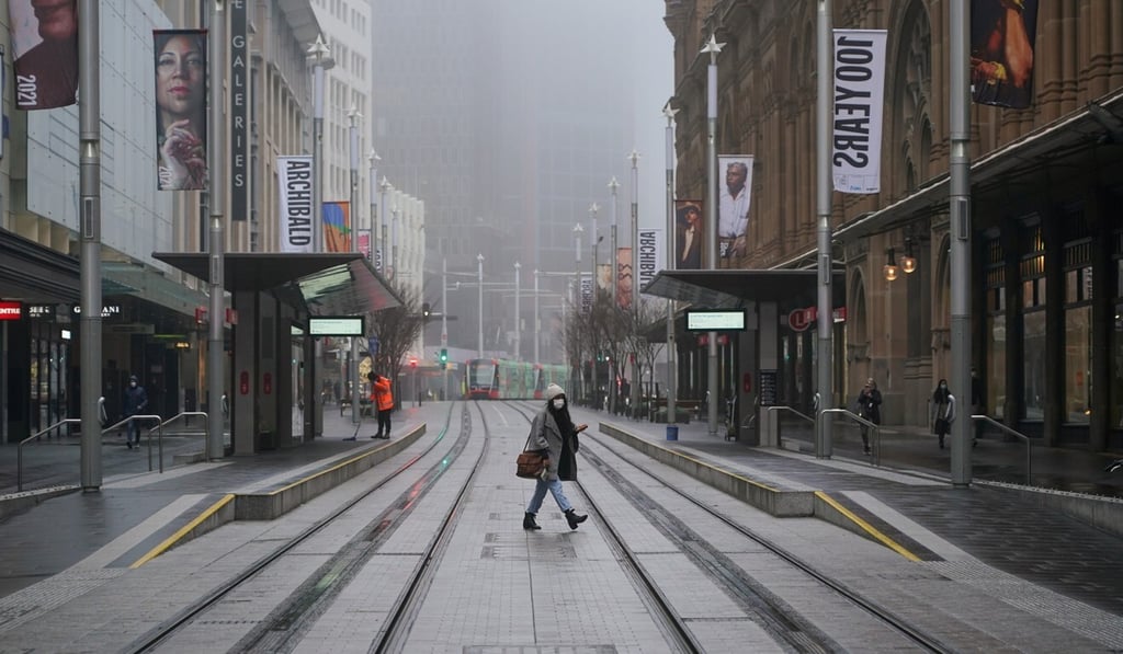 A pedestrian in an empty city centre during Sydney’s lockdown. Photo: Reuters