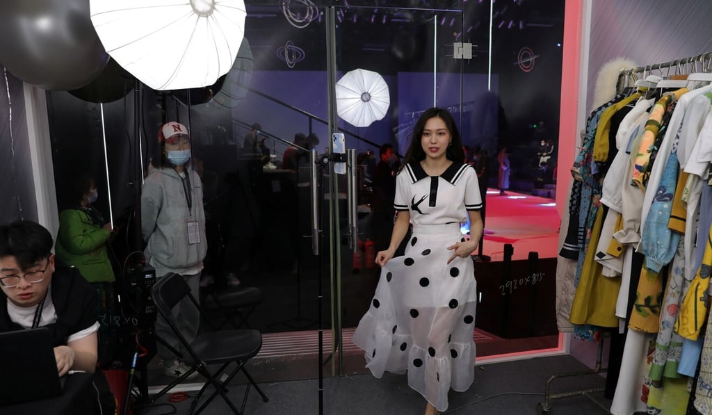 A live streamer promotes a dress by XUNRUO during a live streaming session at China Fashion Week, in Beijing, March 31, 2021. Photo: Reuters