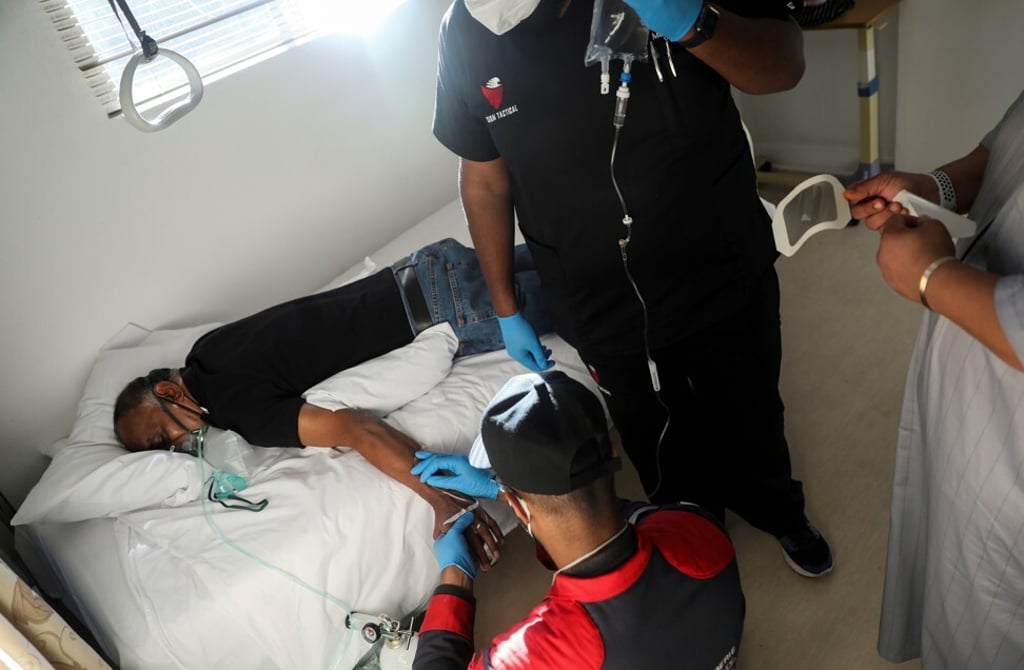 Paramedics attend to a patient during the coronavirus disease outbreak as the country faces tighter restrictions. Photo: Reuters Paramedics attend to a patient during the coronavirus disease outbreak as the country faces tighter restrictions. Photo: Reuters