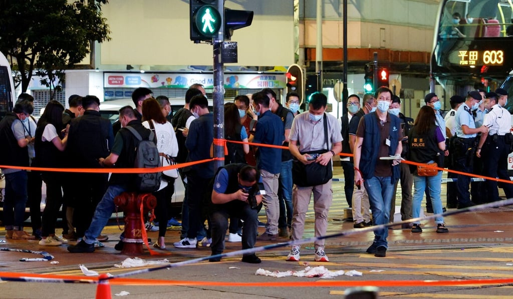 Police investigate the stabbing of an officer in Causeway Bay on July 1 by a man who then turned the knife on himself. Photo: Reuters Police investigate the stabbing of an officer in Causeway Bay on July 1 by a man who then turned the knife on himself. Photo: Reuters