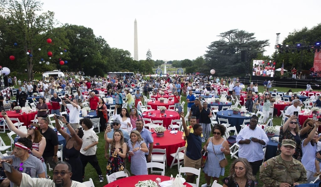 People listen to US President Joe Biden deliver remarks on the South Lawn of the White House. Photo: EPA People listen to US President Joe Biden deliver remarks on the South Lawn of the White House. Photo: EPA