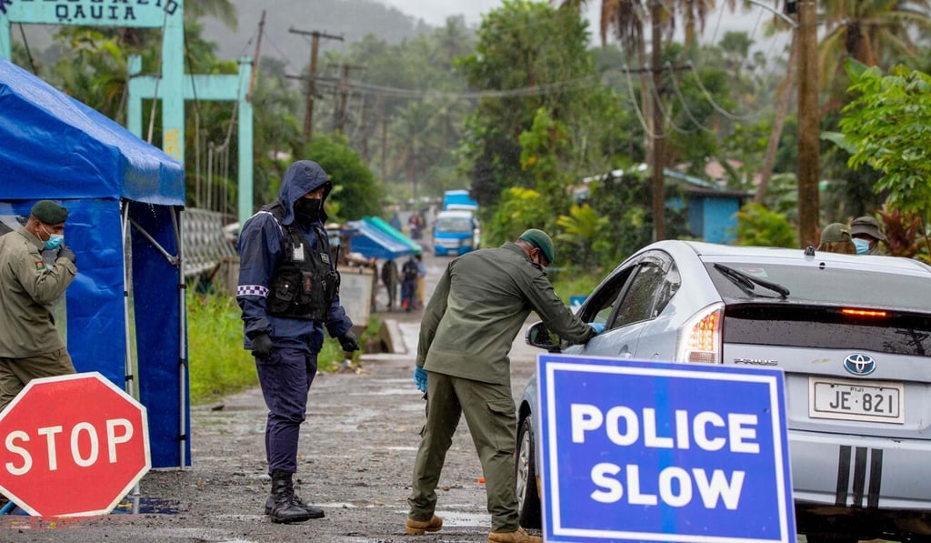 Police enforce mandatory face mask protocols in Fiji's capital Suva last month. Photo: AFP