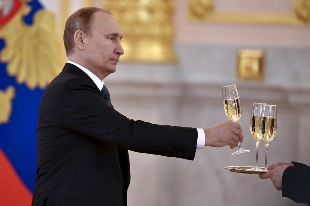Russian President Vladimir Putin holds a glass of champagne at a ceremony in Moscow on April 20, 2016. Photo: Reuters