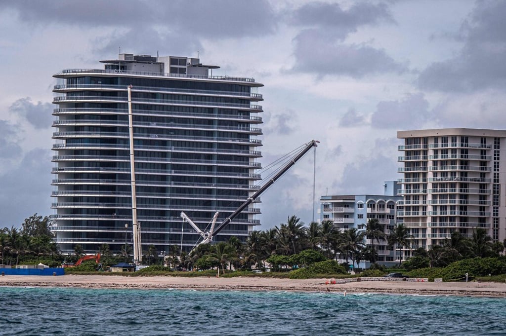 Cranes mark the skyline at the spot where a controlled demolition of the Champlain Towers South block of flats took place on Monday. Photo: AFP