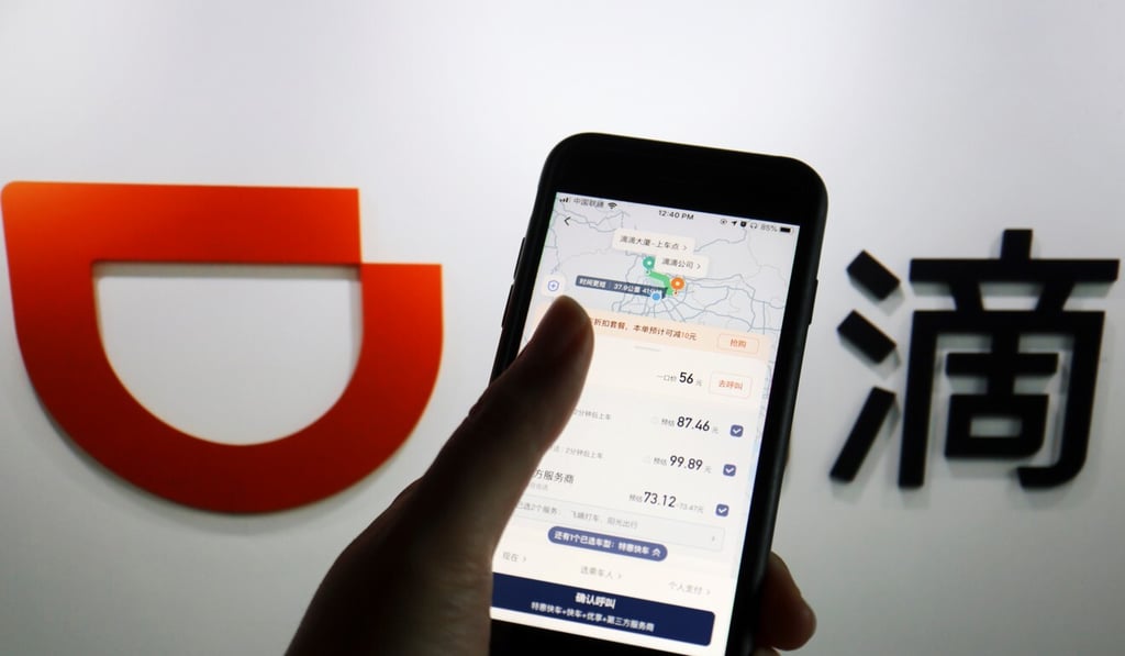 The app of Chinese ride-hailing giant Didi is seen on a mobile phone in front of the company logo. Photo: Reuters The app of Chinese ride-hailing giant Didi is seen on a mobile phone in front of the company logo. Photo: Reuters