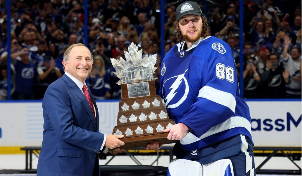 Andrei Vasilevskiy, of the Tampa Bay Lightning, is presented with the Conn Smythe Trophy by NHL Commissioner Gary Bettman. Photo: AFP