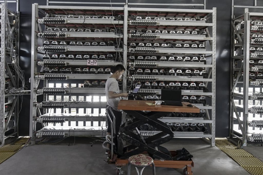 A technician inspects bitcoin mining machines at a facility operated by Bitmain Technologies in Ordos, Inner Mongolia, on August 11, 2017. China’s crackdown on bitcoin mining has turned dozens of companies from model energy consumers into pariahs in the span of a year. Photo: Bloomberg A technician inspects bitcoin mining machines at a facility operated by Bitmain Technologies in Ordos, Inner Mongolia, on August 11, 2017. China’s crackdown on bitcoin mining has turned dozens of companies from model energy consumers into pariahs in the span of a year. Photo: Bloomberg