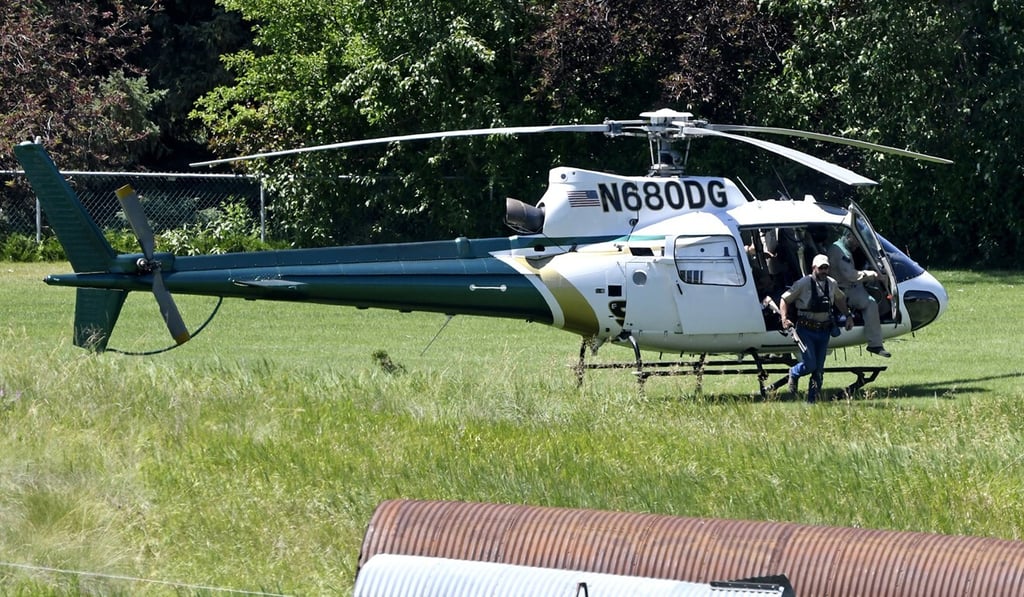 Wildlife officials searched by helicopter for the grizzly bear. Photo; AP