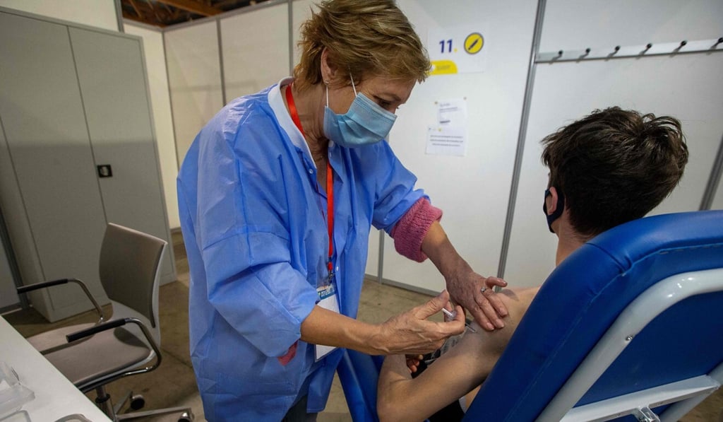 A man receives a Covid-19 vaccine at a vaccination centre in Brussels last month. The Belgian woman infected with two virus variants at once had not been vaccinated. Photo: AFP