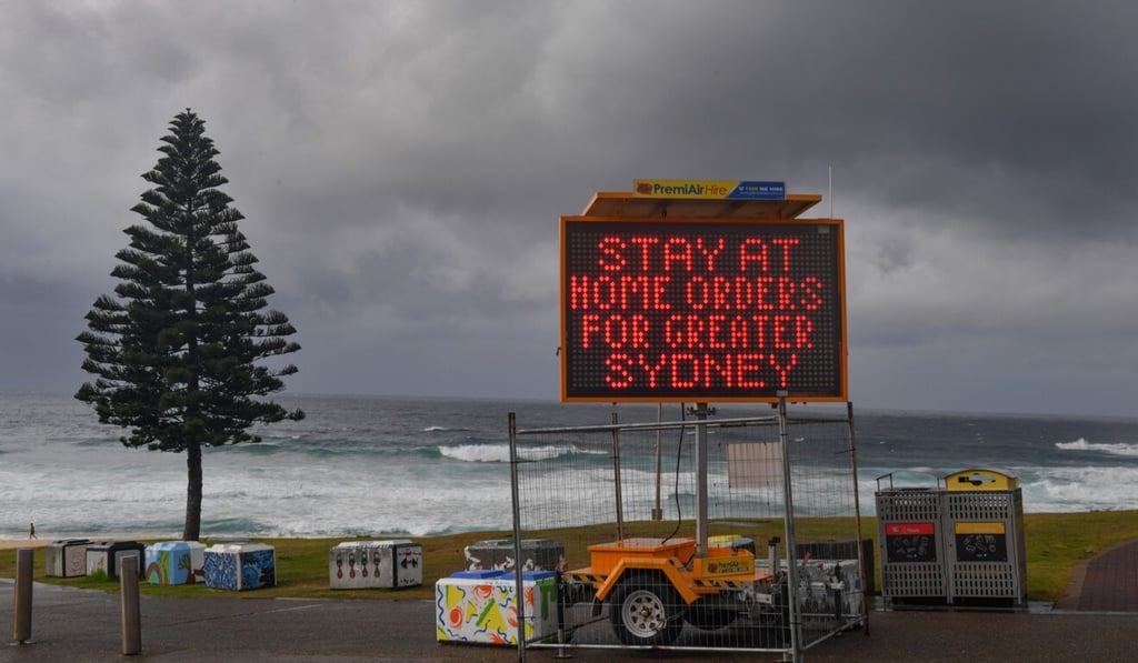 A Covid-19 warning sign is seen at Bondi Beach in Sydney on Saturday. Photo: EPA A Covid-19 warning sign is seen at Bondi Beach in Sydney on Saturday. Photo: EPA