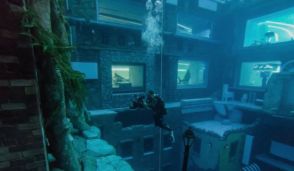 A diver captures images of a mock sunken city at Deep Dive Dubai. Photo: AFP A diver captures images of a mock sunken city at Deep Dive Dubai. Photo: AFP