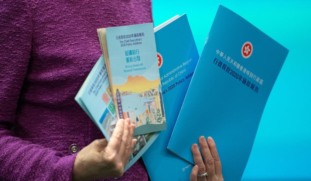 Carrie Lam poses for photographs with copies of last year’s policy address. Photo: Bloomberg Carrie Lam poses for photographs with copies of last year’s policy address. Photo: Bloomberg
