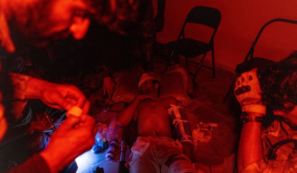 Members of the Afghan Special Forces tend to a soldier injured during a firefight with the Taliban on Sunday. Photo: Reuters