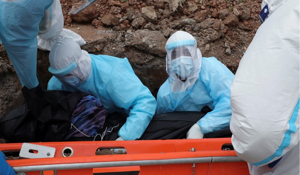 Family members and cemetery workers bury a Covid-19 victim at a cemetery in Shah Alam, Malaysia, on Wednesday. Photo: Reuters Family members and cemetery workers bury a Covid-19 victim at a cemetery in Shah Alam, Malaysia, on Wednesday. Photo: Reuters