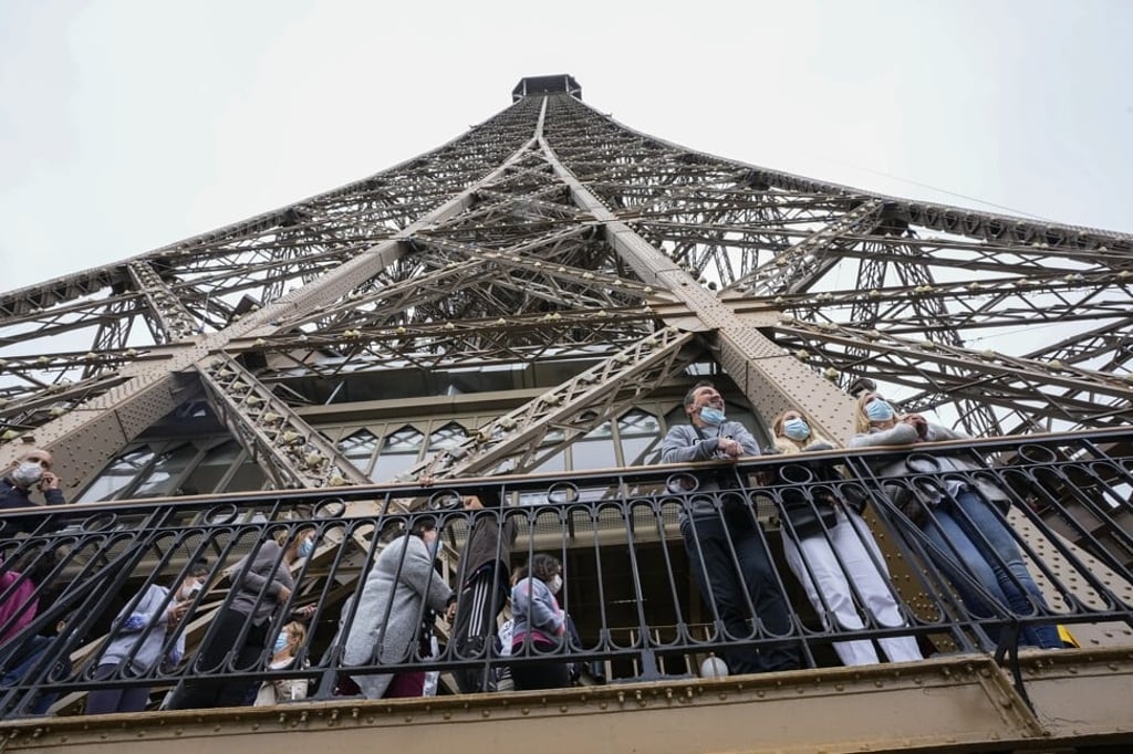 Visitors enjoy the view from the Eiffel Tower on Friday, when the monument opened for the first time in nine months, just as France faces new virus rules aimed at taming the fast-spreading delta variant. Photo: AP Visitors enjoy the view from the Eiffel Tower on Friday, when the monument opened for the first time in nine months, just as France faces new virus rules aimed at taming the fast-spreading delta variant. Photo: AP