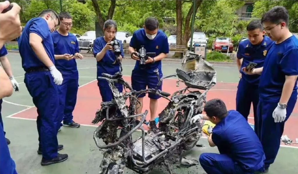 Investigators inspect the charred remains of an e-bike that exploded in China. Photo: Handout