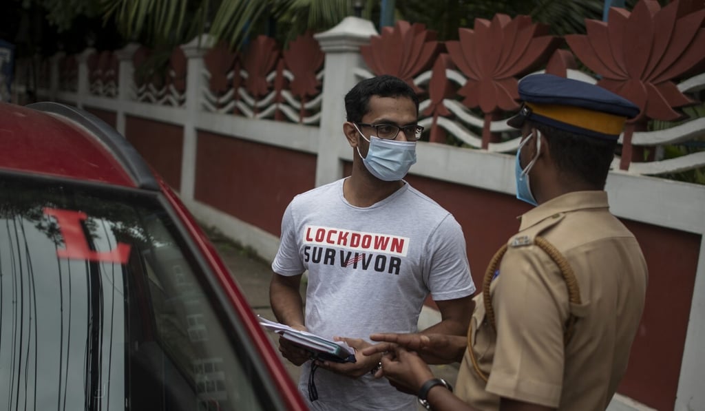 A policeman questions a commuter in Kochi, Kerala, earlier this month for violating coronavirus restrictions. Photo: AP A policeman questions a commuter in Kochi, Kerala, earlier this month for violating coronavirus restrictions. Photo: AP