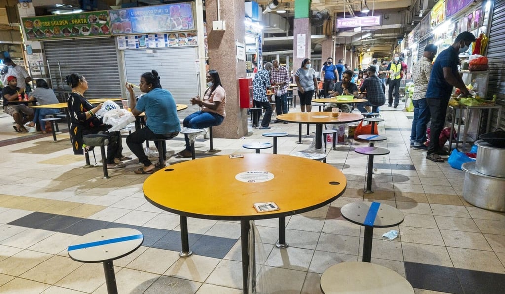 People observe social distancing while eating at a hawker centre in Singapore earlier this week. Photo: Xinhua