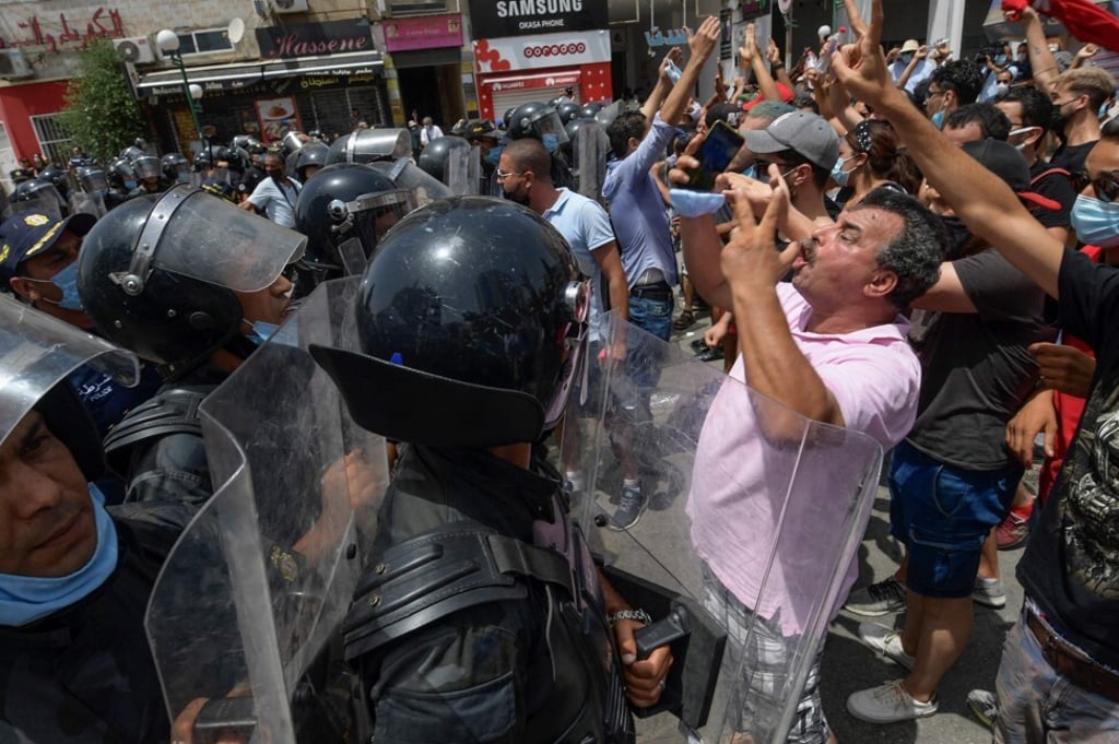 Members of Tunisian security forces face off with anti-government demonstrators during a rally in front of the parliament in Tunis on Sunday. Photo: AFP Members of Tunisian security forces face off with anti-government demonstrators during a rally in front of the parliament in Tunis on Sunday. Photo: AFP