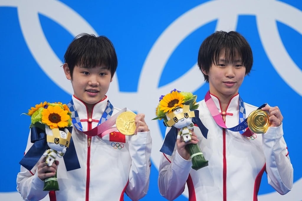 Zhang Jiaqi and Chen Yuxi celebrate with their gold medals. Photo: Xinhua/Xu Chang Zhang Jiaqi and Chen Yuxi celebrate with their gold medals. Photo: Xinhua/Xu Chang