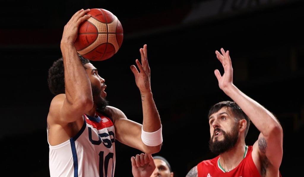 Jayson Tatum of USA in action against Aaron Geramipoor and Michael Rostampour of Iran. Photo: EPA