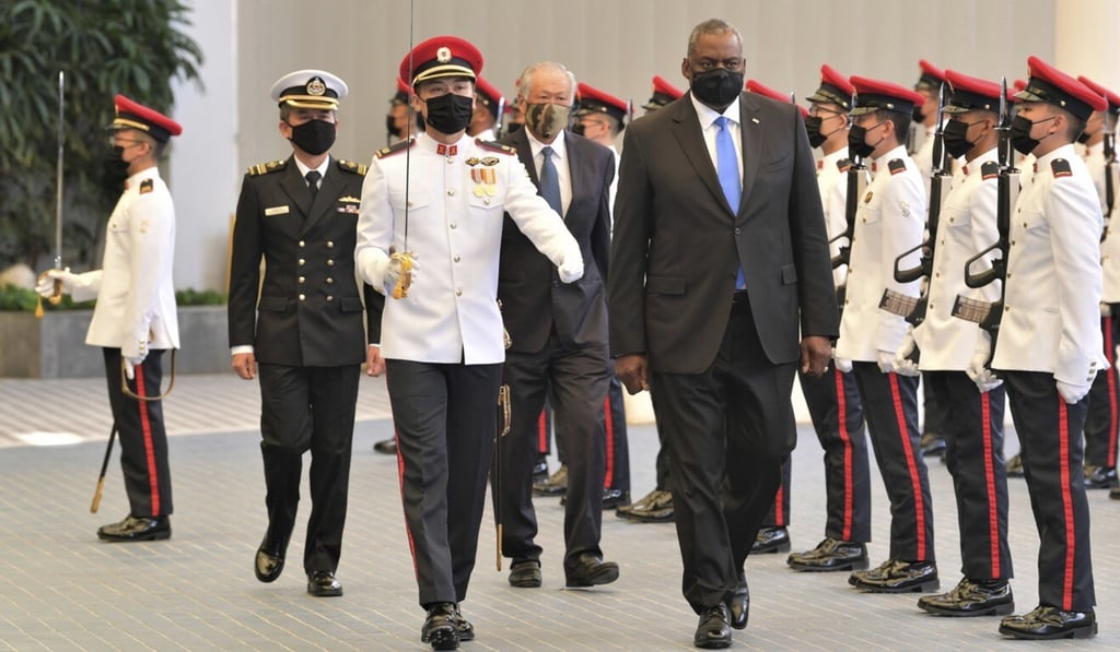 US Defence Secretary Lloyd Austin reviews an honour guard in Singapore on Tuesday. Photo: AP US Defence Secretary Lloyd Austin reviews an honour guard in Singapore on Tuesday. Photo: AP