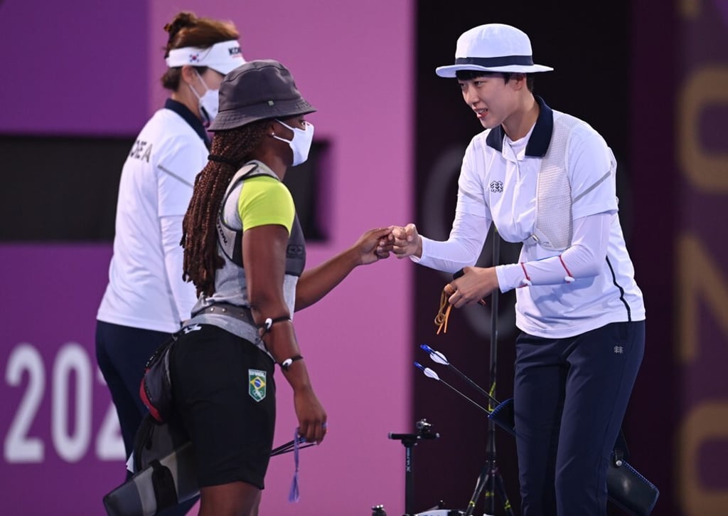 An San of South Korea and Ane Marcelle Dos Santos of Brazil fist-bump after their match. Photo: Reuters