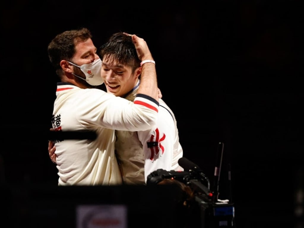 Coach Greg Koenig hugs Cheung Ka-long after his triumph in the men’s individual foil. Photo: Hong Kong Olympic Committee Coach Greg Koenig hugs Cheung Ka-long after his triumph in the men’s individual foil. Photo: Hong Kong Olympic Committee