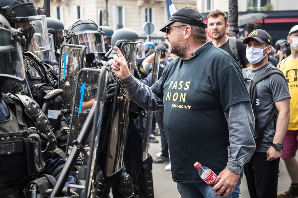 A protester wearing a jersey reading ‘No to Pass’ faces anti-riot police forces in Paris, France, in Paris on Saturday. Photo: EPA-EFE