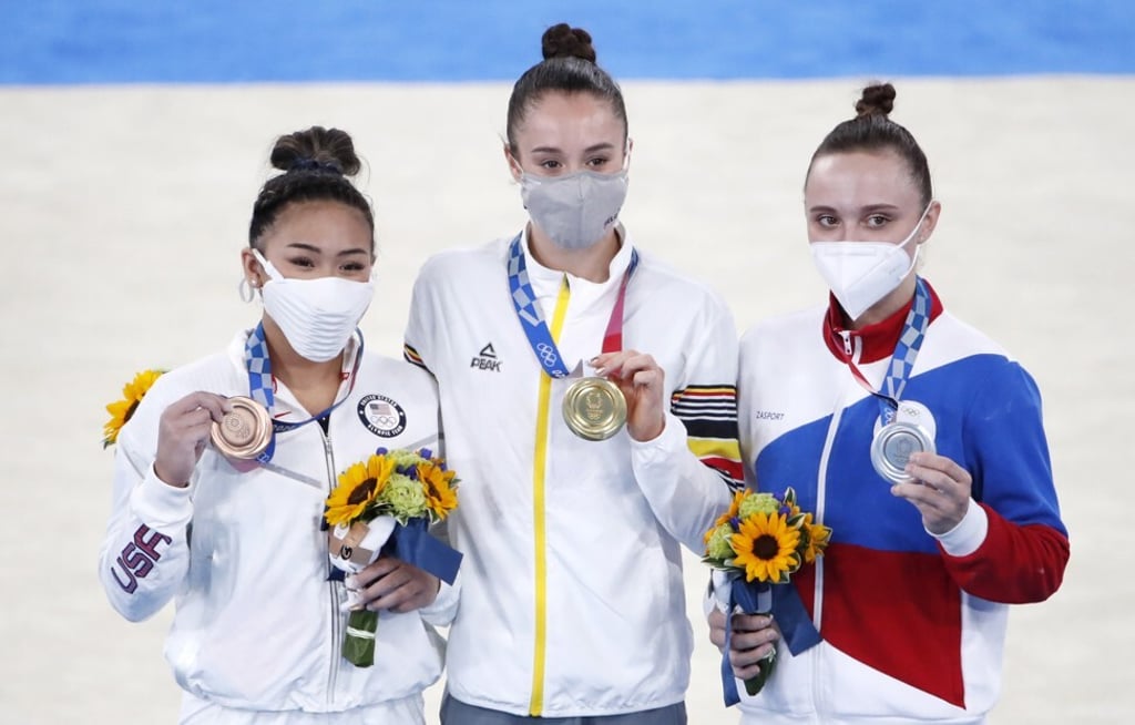 Bronze medallist Sunisa Lee of the US, gold medallist Nina Derwael of Belgium and silver medallist Anastasiia Iliankova of Russia pose during the medal ceremony. Photo: EPA Bronze medallist Sunisa Lee of the US, gold medallist Nina Derwael of Belgium and silver medallist Anastasiia Iliankova of Russia pose during the medal ceremony. Photo: EPA