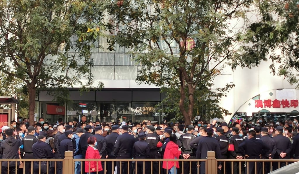 Some 200 people gathered outside the office of Youwin Education in Beijing demanding refunds after a private tutoring school went out of business before the current crackdown. Photo: SCMP