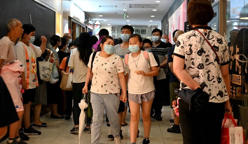 Students and parents leave after attending a private after-school class in Beijing. The private tutoring sector is the target of a crackdown. Photo: AFP
