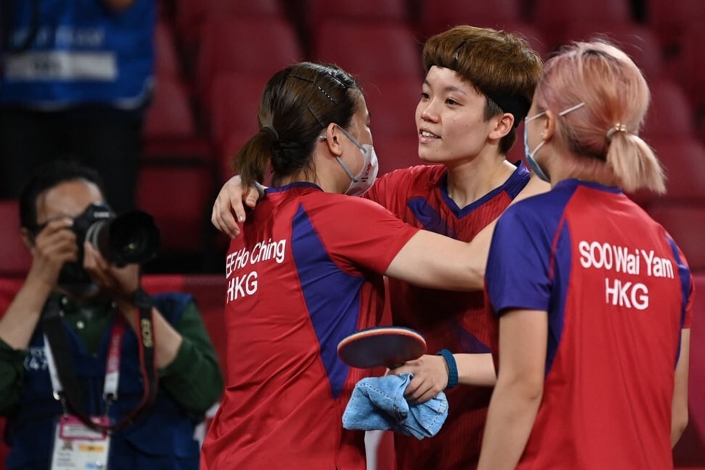 Doo Hoi-kem (centre) celebrates with Lee Ho-ching and Minnie Soo Wai-yam after beating Romania's Daniela Dodean. Photo: AFP