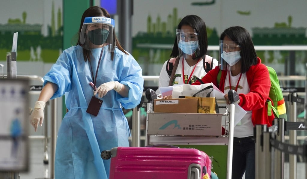 Passengers arrive at the Hong Kong International Airport in April before being transported to designated quarantine hotels. Photo: Winson Wong