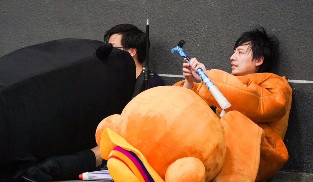 The heat took a toll on those stuck in lengthy queues outside the Convention and Exhibition Centre. Photo: Felix Wong