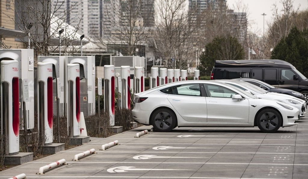 Tesla electric vehicles are parked next to charging stations outside one of the company's showrooms in Beijing. Photo: Bloomberg Tesla electric vehicles are parked next to charging stations outside one of the company's showrooms in Beijing. Photo: Bloomberg