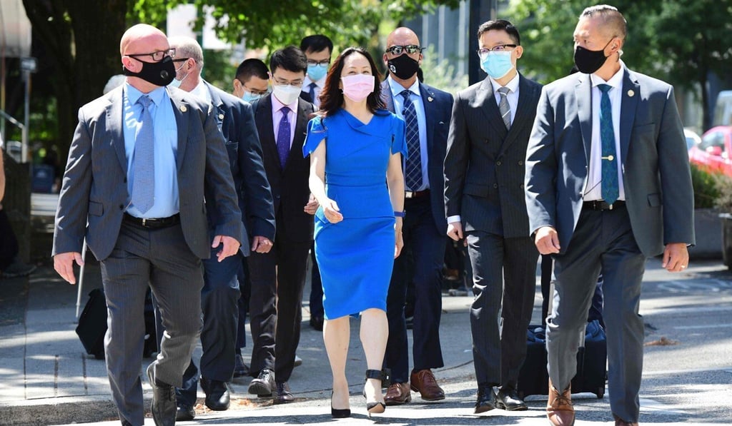 Meng Wanzhou returns to the Supreme Court of British Columbia in Vancouver with her security detail after a lunch break in her extradition hearing on Wednesday. Photo: AFP