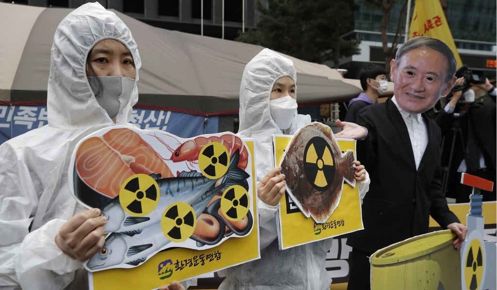 Environmental activists, one wearing a mask of Japanese Prime Minister Yoshihide Suga, protest near the Japanese embassy in Seoul earlier this year. Photo: AP Environmental activists, one wearing a mask of Japanese Prime Minister Yoshihide Suga, protest near the Japanese embassy in Seoul earlier this year. Photo: AP