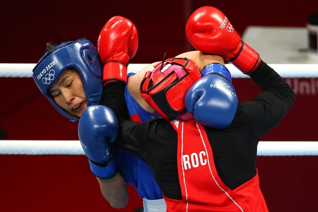 Zemfira Magomedalieva of Team ROC exchanges with China’s Qian Li. Photo: Buda Mendes/Getty Images