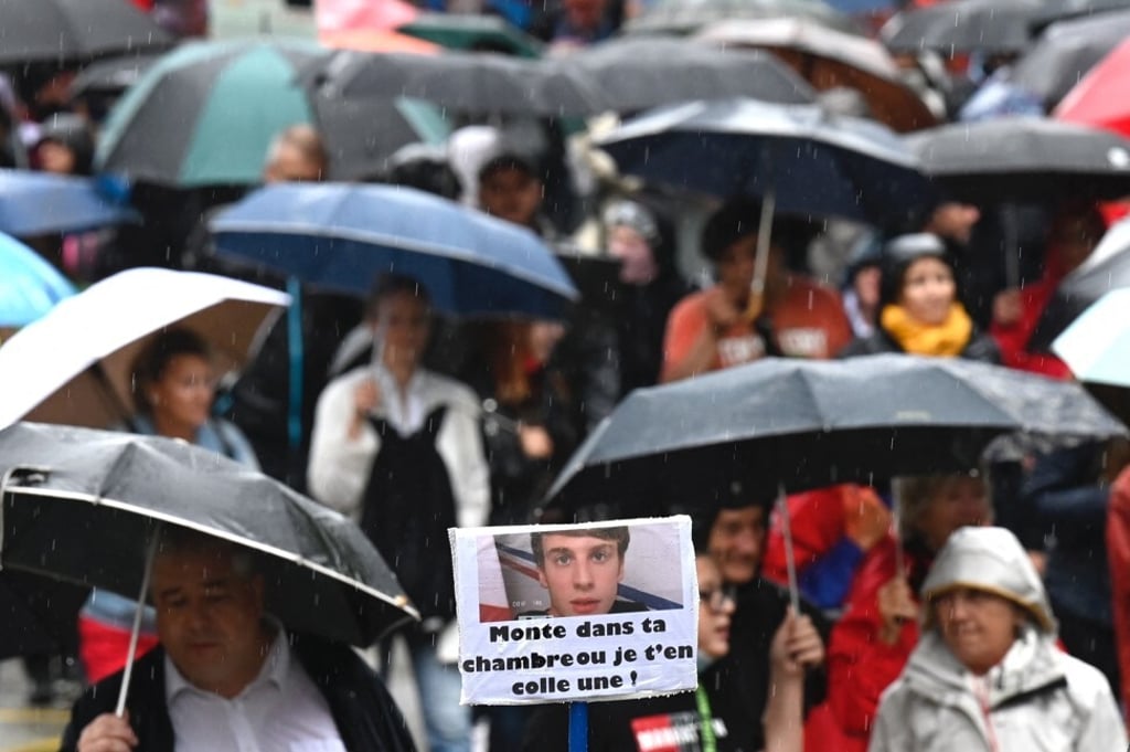 A woman holds a sign with French President Emmanuel Macron’s face, reading ‘Go up to your room or I'll slap you’ as she takes part in a protest in Mulhouse, France, on Saturday. Photo: AFP