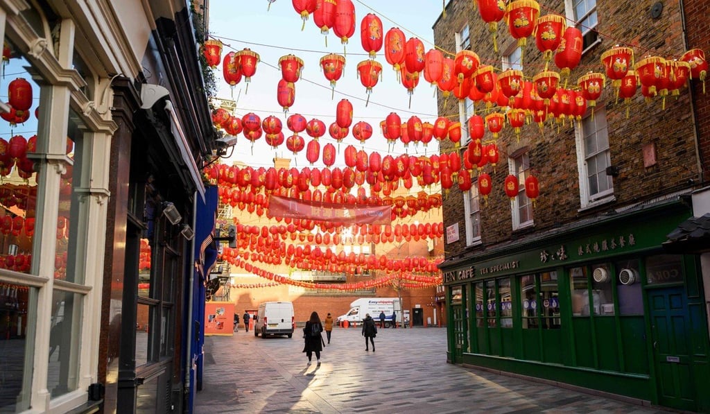 Pedestrians walk through the almost deserted streets of London's Chinatown district last year. Photo: AFP