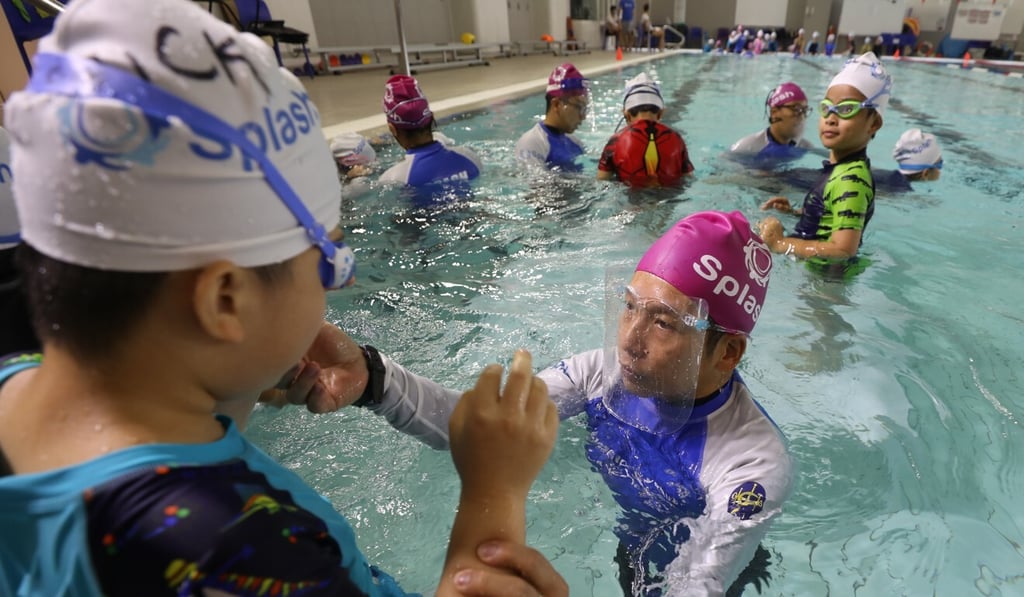Ricky (in white cap) learns swimming from coach C.K. Kan, a coach with the Splash Foundation in Hong Kong. Photo: Xiaomei Chen